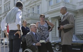 Max Vernon (wheelchair) talks to actor Mark Strong on the set of 6 Days.