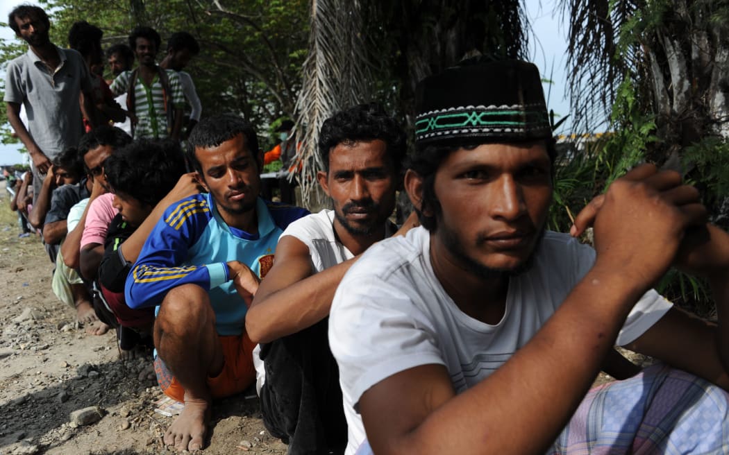 Migrants from Bangladesh line up to be documented by Indonesian immigration personnel Langsa in Aceh province.