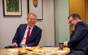 Prime Minister Chris Hipkins and Finance Minister Grant Robertson having a sausage roll ahead of the Budget announcement on 18 May, 2023.