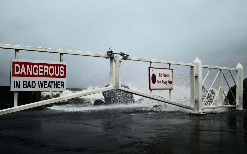 Waves crash over the breakwater at Port Taranaki.