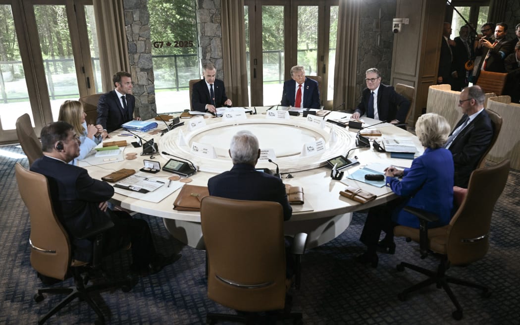 (L/R, clockwise) Japan's Prime Minister Shigeru Ishiba, Italy's Prime Minister Giorgia Meloni, French President Emmanuel Macron, Canadian Prime Minister Mark Carney, US President Donald Trump, British Prime Minister Keir Starmer, German Chancellor Friedrich Merz, European Commission President Ursula Von der Leyen, and European Council President António Costa attend a working session during the Group of Seven (G7) Summit at the Pomeroy Kananaskis Mountain Lodge in Kananaskis, Alberta, Canada on June 16, 2025. (Photo by Brendan SMIALOWSKI / AFP)