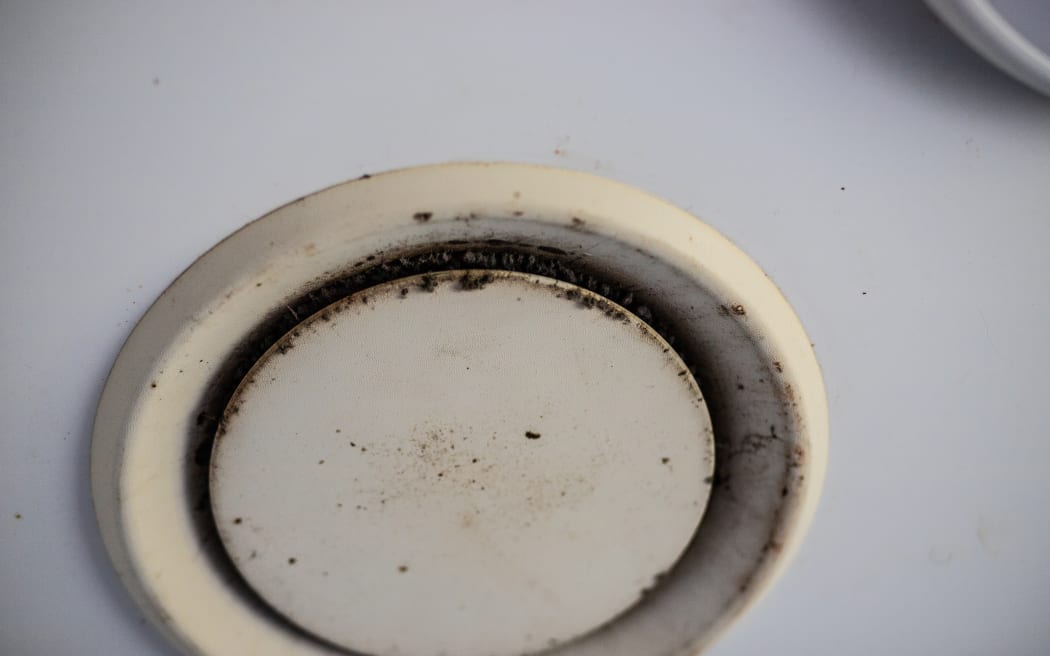 An extractor fan in the Kainga Ora resident's home is covered in mould.