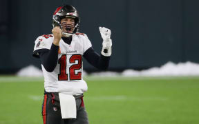 Tom Brady #12 of the Tampa Bay Buccaneers celebrates in the final seconds of their 31 to 26 win over the Green Bay Packers during the NFC Championship game at Lambeau Field on January 24, 2021 in Green Bay, Wisconsin.