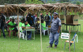 Police and electoral officials call out names of voters to come and vote, Timini, Morobe Province.