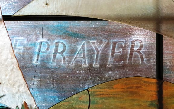 Contemporary stained glass etched with the word "prayer" at St Luke's Church, Remuera, Auckland.
