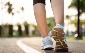 Close up of woman runner shoes in the park.