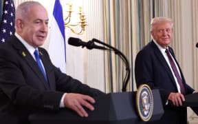 WASHINGTON, DC - SEPTEMBER 29: U.S. President Donald Trump (R) looks on as Israeli Prime Minister Benjamin Netanyahu delivers remarks during a joint news conference in the State Dining Room at the White House on September 29, 2025 in Washington, DC. President Trump welcomed Netanyahu for his fourth visit to the White House, where the two leaders met to discuss the latest U.S. backed plans to end the war in Gaza and secure the release of the remaining hostages held by Hamas.   Win McNamee/Getty Images/AFP (Photo by WIN MCNAMEE / GETTY IMAGES NORTH AMERICA / Getty Images via AFP)