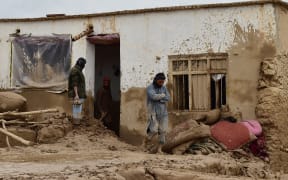 Afghan men clear debris and mud from a damaged house following a flash flood after a heavy rainfall in Laqiha village of Baghlan-i-Markazi district in Baghlan province on May 11, 2024. At least 62 people, mainly women and children, were killed on May 10 in flash flooding that ripped through Afghanistan's Baghlan province, in the north of the country, a local official told AFP.