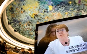 New High Commissioner for Human Rights Michelle Bachelet is seen on a TV screen delivering her speech during the opening day of the 39th UN Council of Human Rights in Geneva on September 10, 2018.