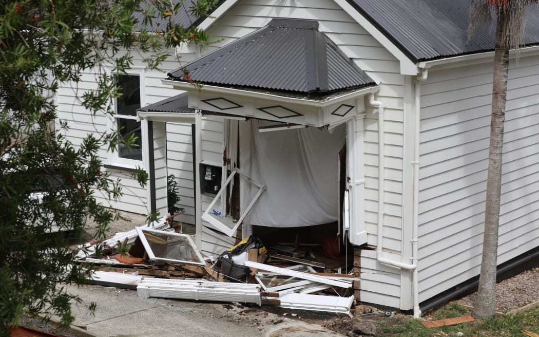 Two homes were damaged after a car left Don Buck Road and drove down a bank, through the lounge of one property and ended up in the bedroom of a neighbouring one.