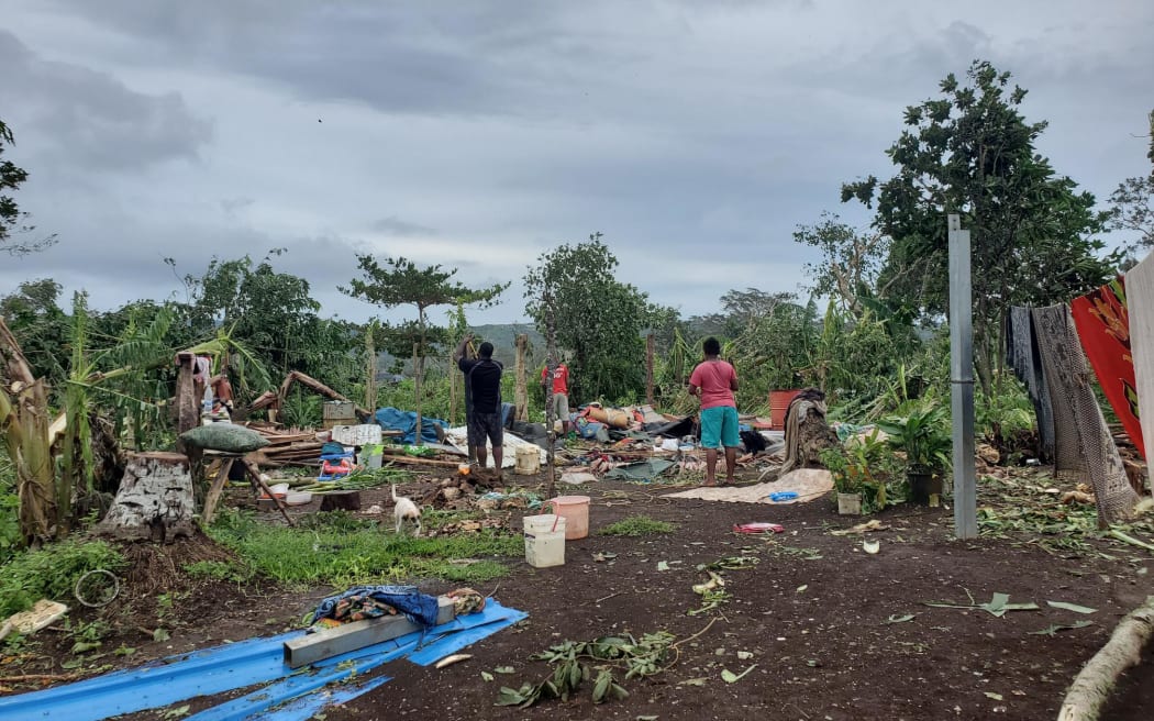 A Ni-Vanuatu family salvage what is left of their home in the aftermath of Cyclone Judy.