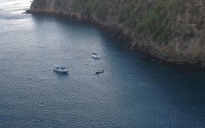Boats searching at the scene of the helicopter crash.