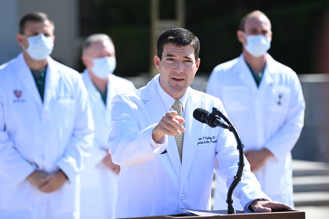 White House physician Sean Conley answers questions surrounded by other doctors, during an update on the condition of US President Donald Trump, on October 4, 2020, at Walter Reed Medical Center in Bethesda, Maryland.
