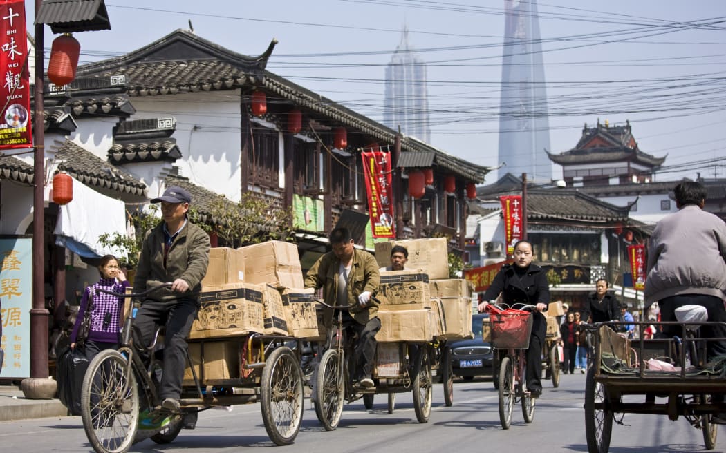 Busy street scene in Old Shanghai, China (Photo by TIM GRAHAM / Robert Harding Heritage / robertharding via AFP)