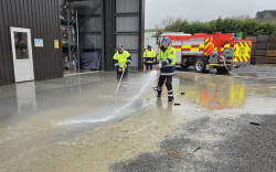 Firefighters help with the clean-up at The Limery in Wairoa, after the flooding of July 2026.