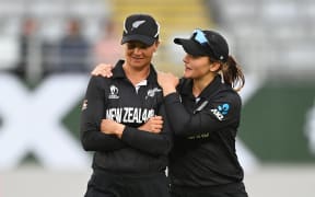 Suzie Bates and Amelia Kerr at the end of the match after losing to England.