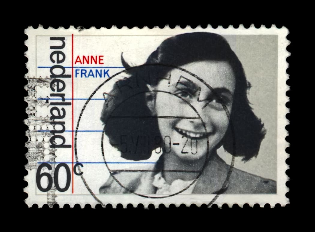 NETHERLANDS - CIRCA 1980: canceled postal stamp printed in the Netherlands shows Anne Frank, 35th anniversary of liberation from the Germans, circa 1980. Vintage stamp isolated on black background.