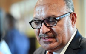 Papua New Guinea Prime Minister Peter O'Neill talks to the media as he visits the international media center, set up for Asia-Pacific Economic Cooperation (APEC) summit, in Port Moresby on November 14, 2018. (Photo by Saeed KHAN / AFP)