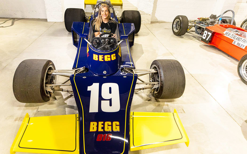 Marie Kolasinski, one of the organisers of the George Begg Festival at Teretonga Park from March 30-April 2, tries out a George Begg built car, at Motorcycle Mecca in Invercargill.