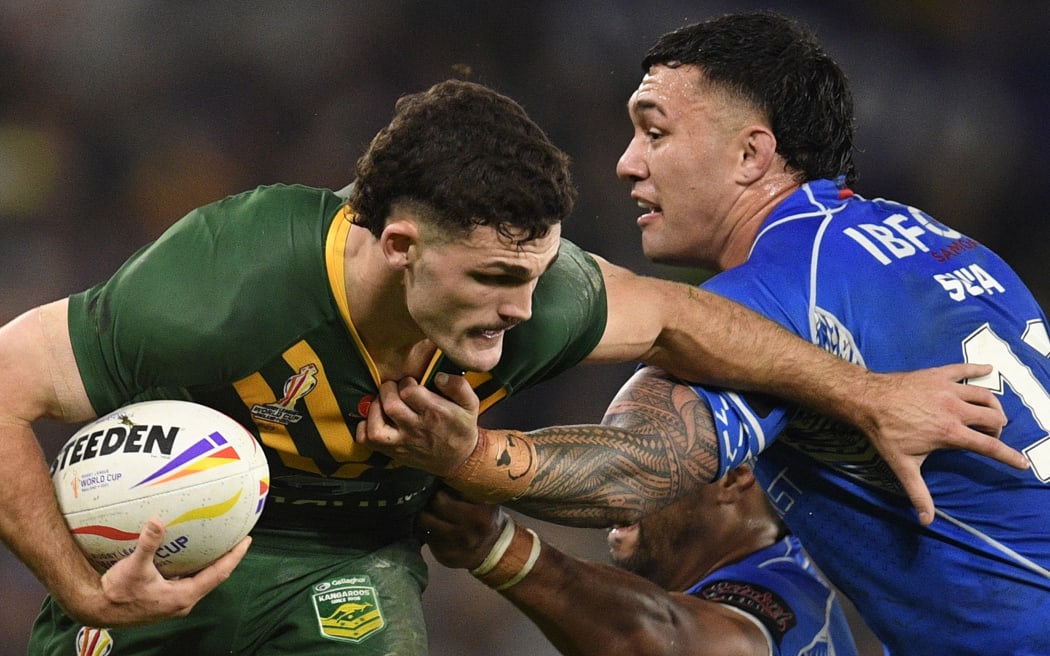 Samoa's Jaydn Su'a (R) tackles Australia's Nathan Cleary during the Rugby League World Cup Men's final between Australia and Samoa at Old Trafford stadium.