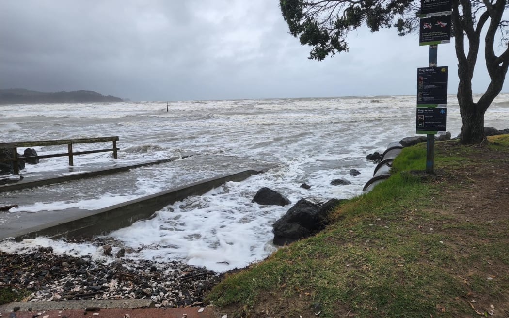 Waves at Auckland's Orewa Beach lash the shore this evening.