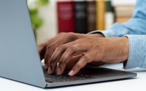 Closeup shot of a unrecognizable business person typing on a laptop keyboard