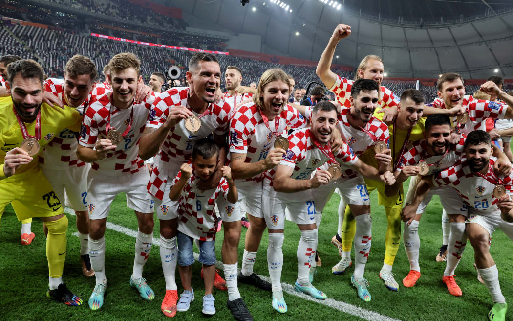 Croatia's players celebrate with their medals after winning the Qatar 2022 World Cup third place play-off football match between Croatia and Morocco at Khalifa International Stadium in Doha on December 17, 2022. (Photo by JACK GUEZ / AFP)