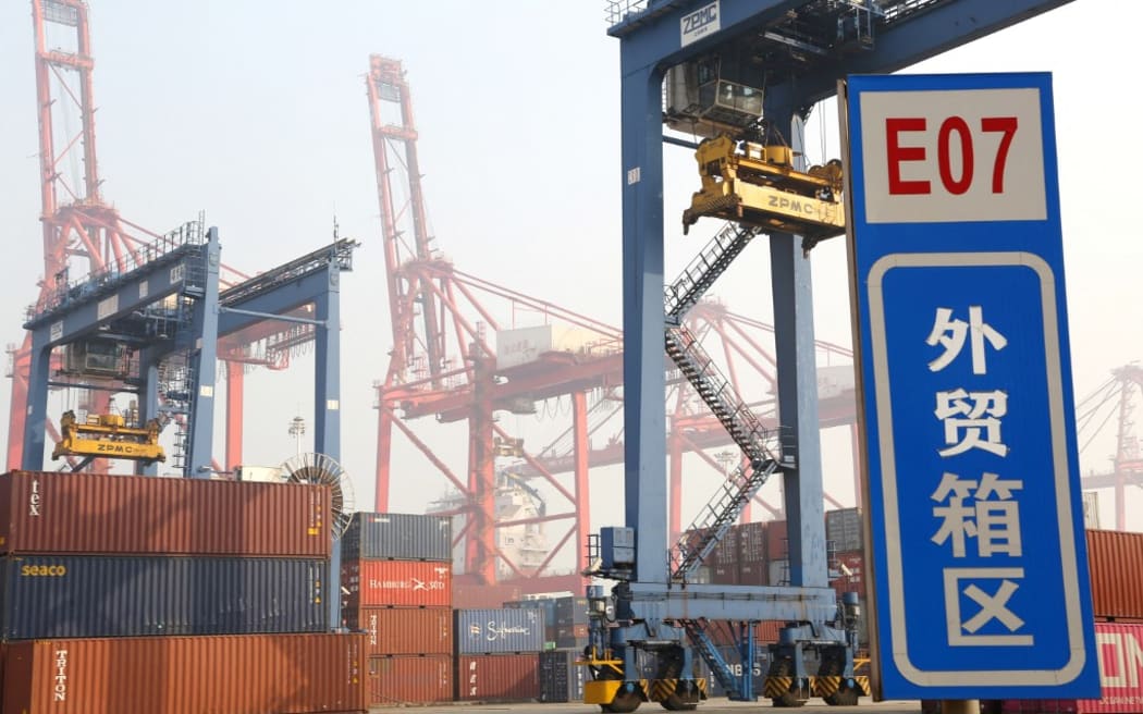 Cranes lift  containers at the Lianyungang Port, which is among the 10 largest ports in China  Lianyungang city, east Chinas Jiangsu province, 7 November 2020.