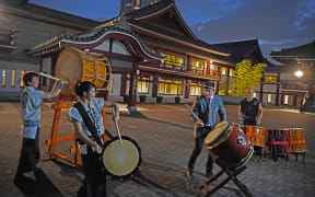 All Black Brad Webber plays drums after a welcome ceremony at Zojoji temple in Tokyo on September 14, 2019.