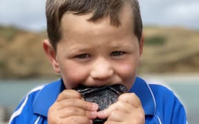 Rydge Lanauze eating paua