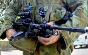 Australian soldiers armed with machineguns man a security post near the Nicolau Lobato international airport in Dili, 26 October 2006.