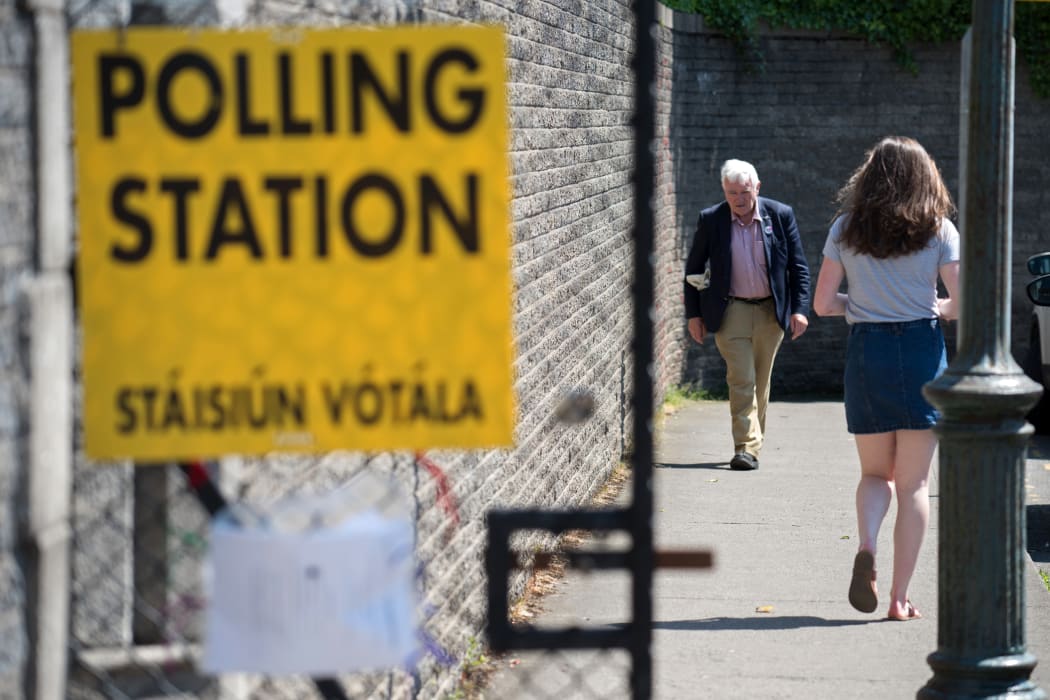 Voters arrive and leave St. Patrick's Boys National School polling station in Drumcondra, Dublin, to vote in the Irish referendum on liberalising abortion law on 25 May.