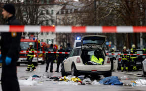 Members of the emergency services work at the scene where a car drove into a crowd in the southern German city of Munich on 13 February 13, 2025 leaving several people injured, police said. Munich police said on social media platform X that "several people were injured" after "a car drove into a group of people" in the centre of the Bavarian state capital. (Photo by Michaela STACHE / AFP)