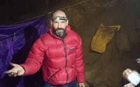 US caver Mark Dickey speaks to the camera while standing at a camp in the Morca Cave of the Taurus Mountains in southern Turkey. A US explorer trapped deep in a Turkish cave with internal bleeding said in a video released to AFP on Friday that he needed "a lot of help" getting out. Mark Dickey, 40, reported falling sick on September 2, while exploring the Morca Cave in southern Turkey's Taurus Mountains with an international team. Dickey fell ill at a depth of 1,120 metres (3,675 feet) and has been resting at a base camp located 1,040 metres underground. (Photo by HANDOUT / TURKISH DIRECTION OF COMMUNICATION / AFP) / RESTRICTED TO EDITORIAL USE - MANDATORY CREDIT "AFP PHOTO/TURKISH DIRECTION OF COMMUNICATION " - NO MARKETING NO ADVERTISING CAMPAIGNS - DISTRIBUTED AS...