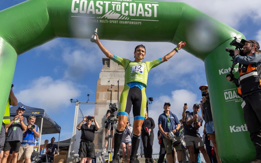 Alex Hunt from Tasmania celebrates after the winning the Coast to Coast Longest Day men's race at New Brighton, Christchurch. 8 Feb, 2025.
