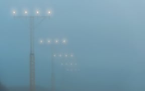 Landing lights at a airport during foggy weahter, help airplanes find the runway approach