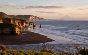 The Three Sisters with Taranaki's coastlines and Mt Taranaki in the background.