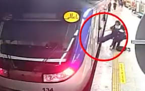 CCTV footage released by authorities shows a girl being pulled unconscious from the metro train in Tehran.