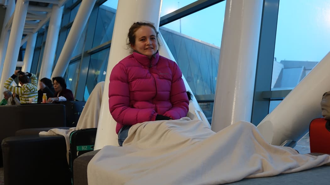 Passenger Abby Katon bunks down at Wellington Airport.