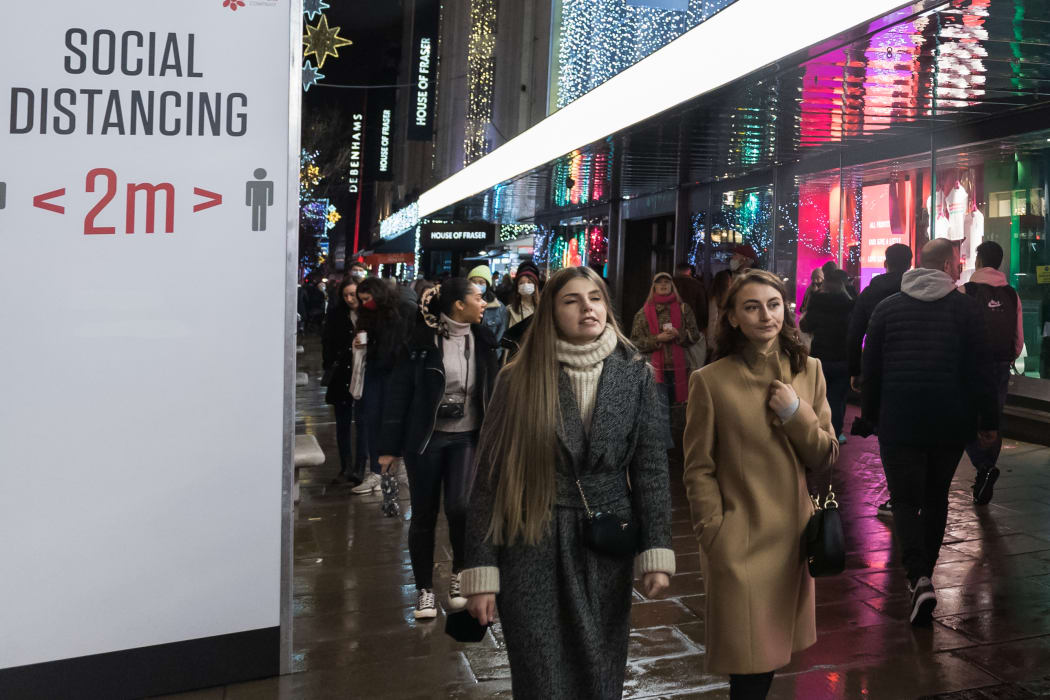 Shoppers walk along Oxford Street after new coronavirus restrictions were announced by British Prime Minister Boris Johnson.