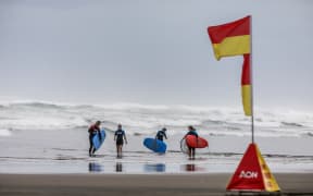 Students learn water safety as well as how to surf