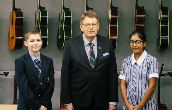 The principal of St Andrew’s Cathedral School John Collier with two students