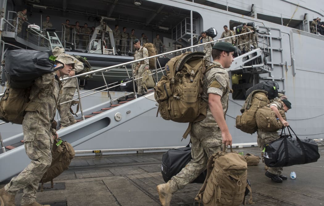 Army personnel disembark from the HMNZS Canterbury.