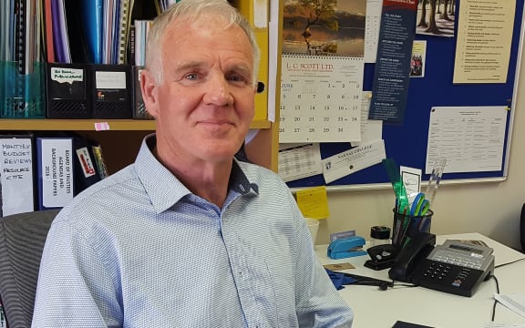 Head and shoulders photo of man in an office.