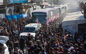 Buses carrying Palestinians released from Israeli prisons under a Gaza ceasefire and hostage exchange deal with Palestinian factions, arrive outside the Nasser hospital in Khan Yunis in the southern Gaza Strip on 13 October, 2025.