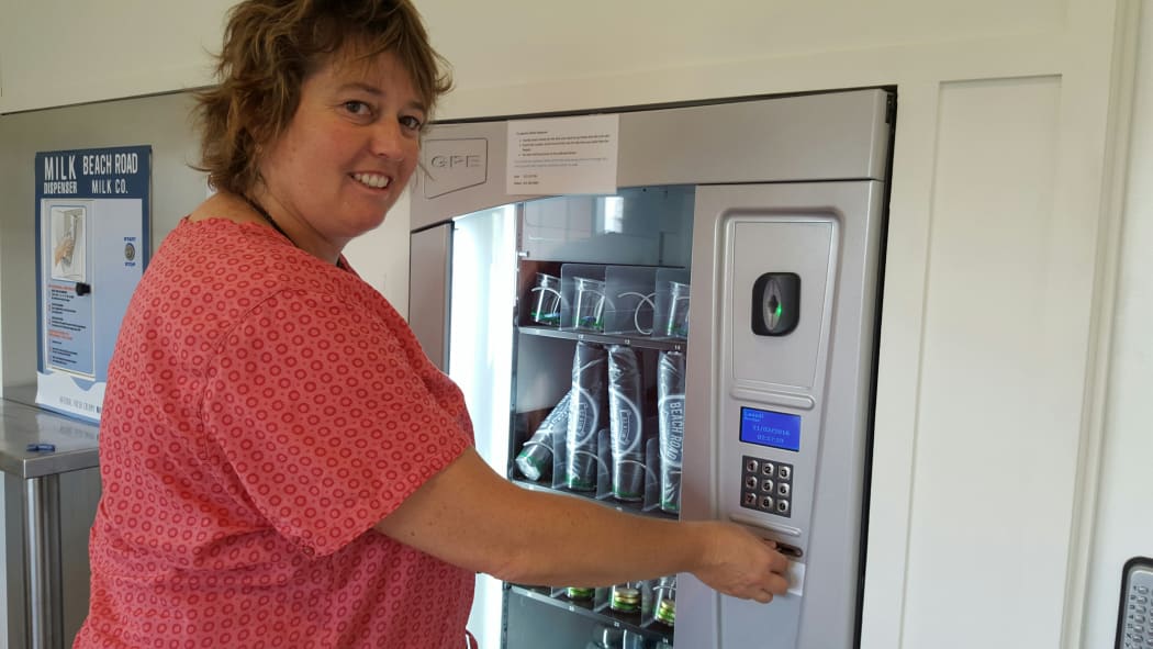 New Plymouth woman Regima Jolly picks up milk from the Beach Road Milk Company vending machine at the farmgate.