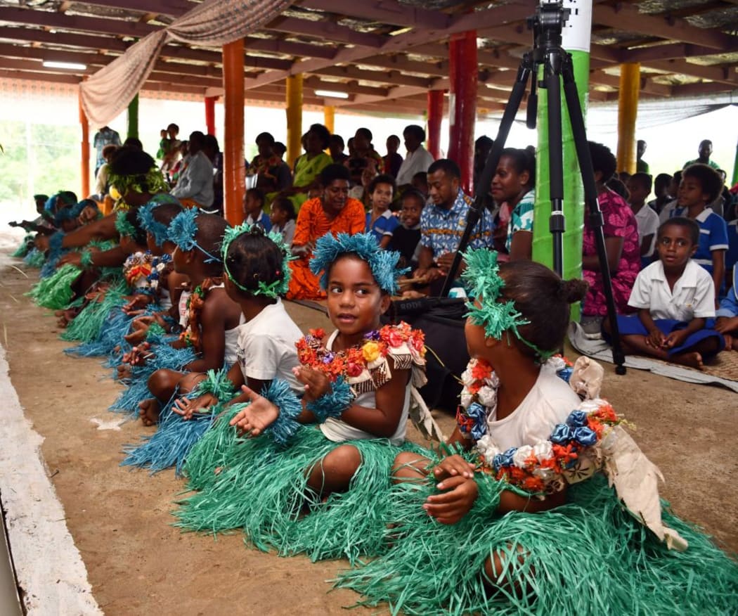 Children perform a traditional Fijian dance at Naivicula.