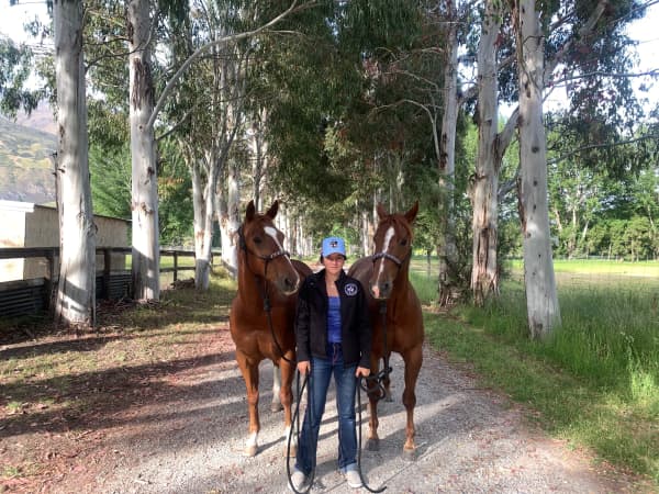 Zoe Johnston, 17, stands with her two horses Jagger and Chase behind her on her family's 25-acre rural property in central Otago.