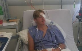 Jack Grunfeld in hospital after receiving a permanent eye injury on a school trip.