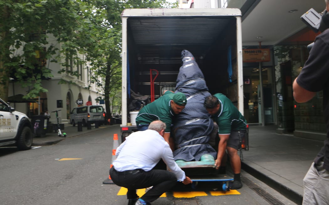 The packaged gone is unloaded at the Gow Langsford Gallery.
